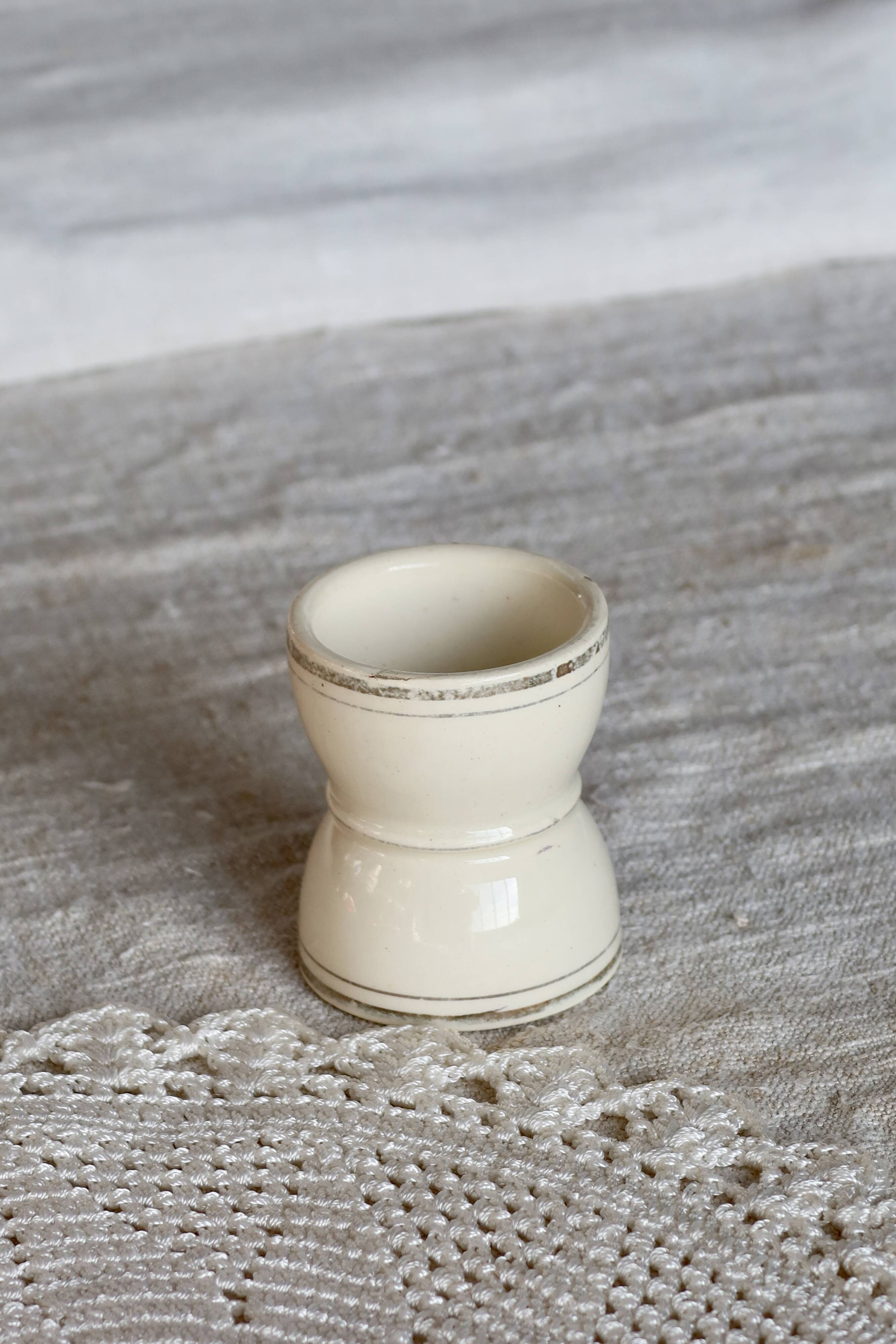 Antique egg cup, ironstone diabolo, ivory and gold edging