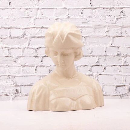Bust of a young woman in cracked white porcelain.