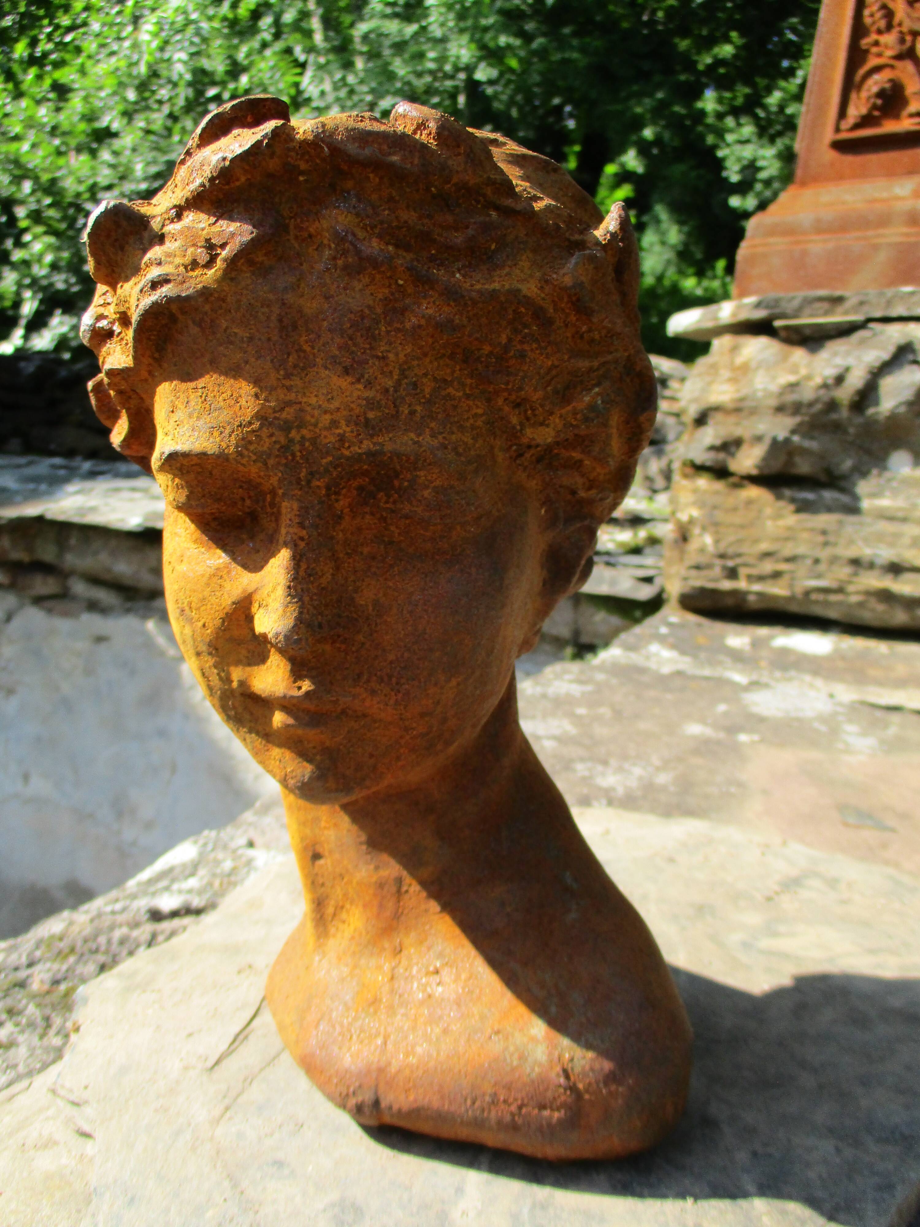 Cast iron sculpture of a woman.