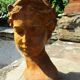 Cast iron sculpture of a woman.