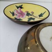 A pair of vintage Chinese decorative plates with floral designs on a yellow background.