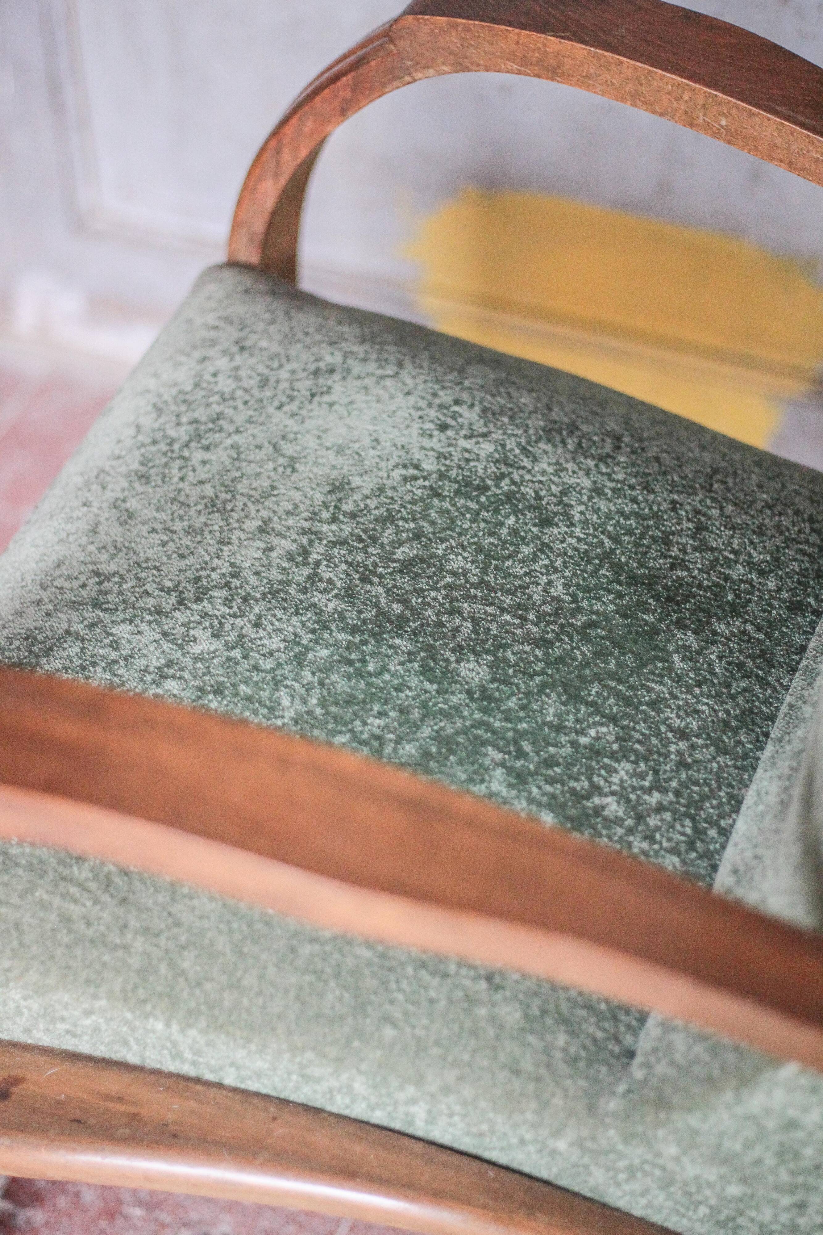 Art Deco armchair in wood and green fabric, living room armchair, interior decor.