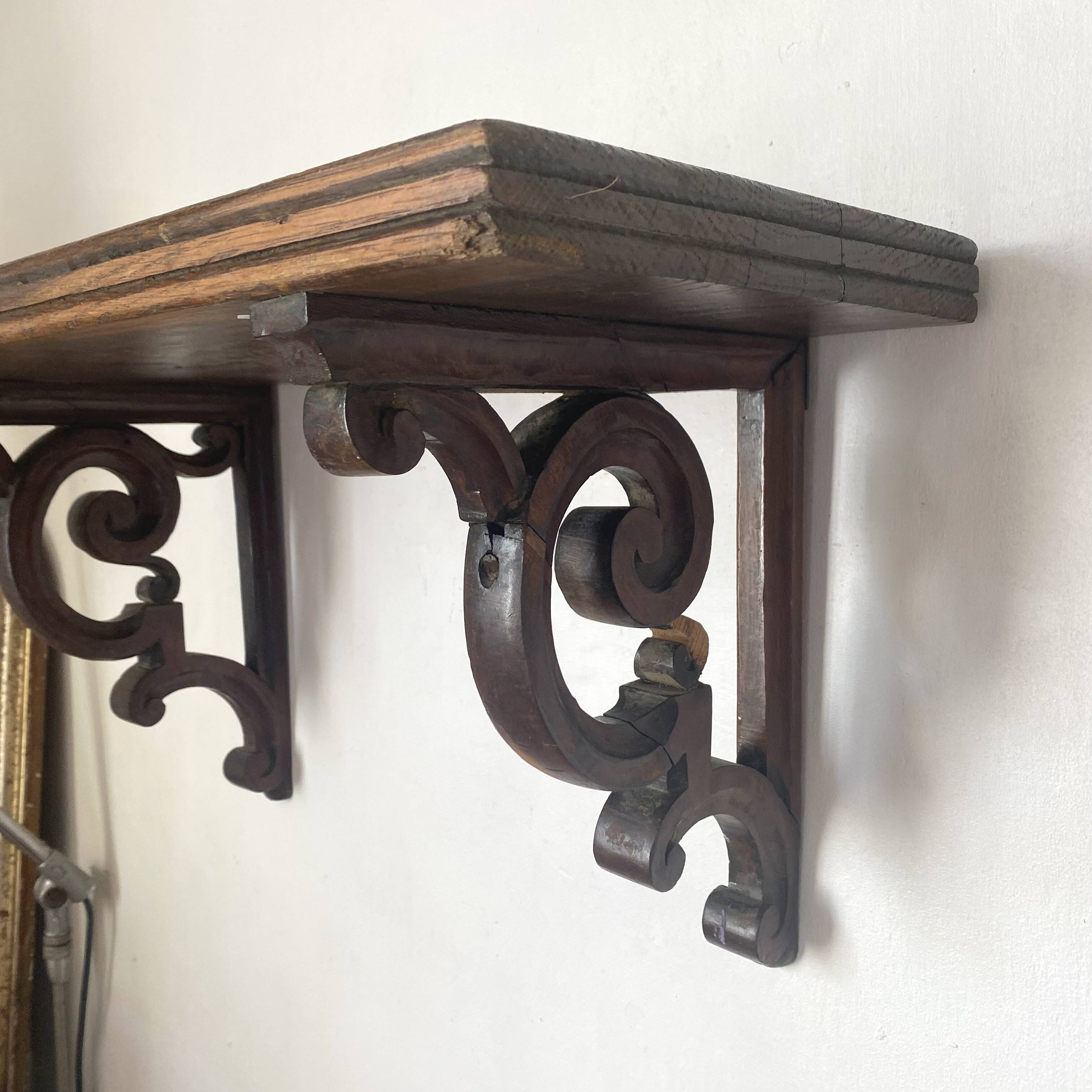 antique oak wall shelf with carved brackets