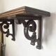antique oak wall shelf with carved brackets