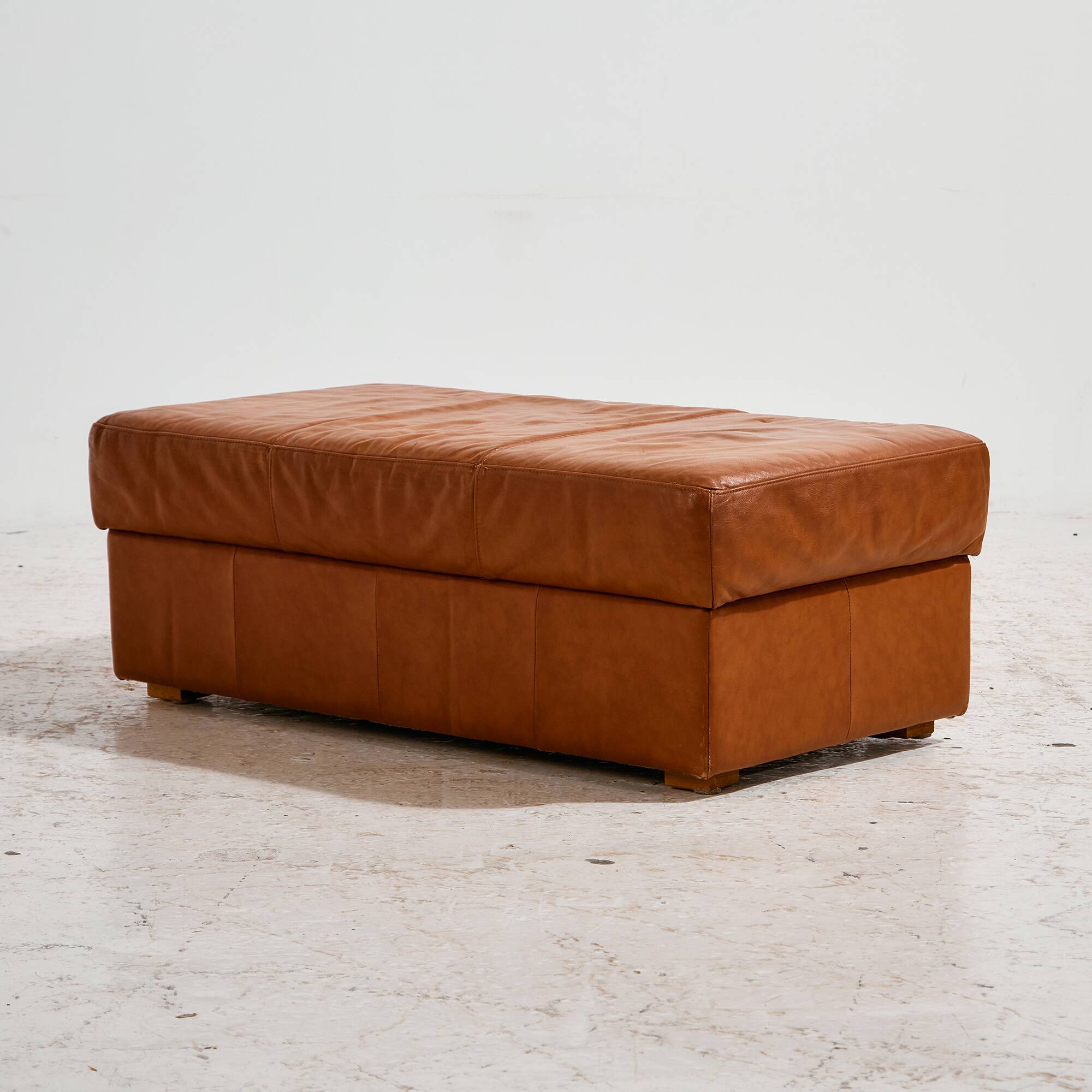 Ottoman with leather upholstery