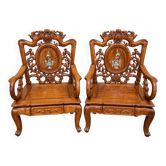 Pair of Asian armchairs in carved wood with mother-of-pearl inlays.
