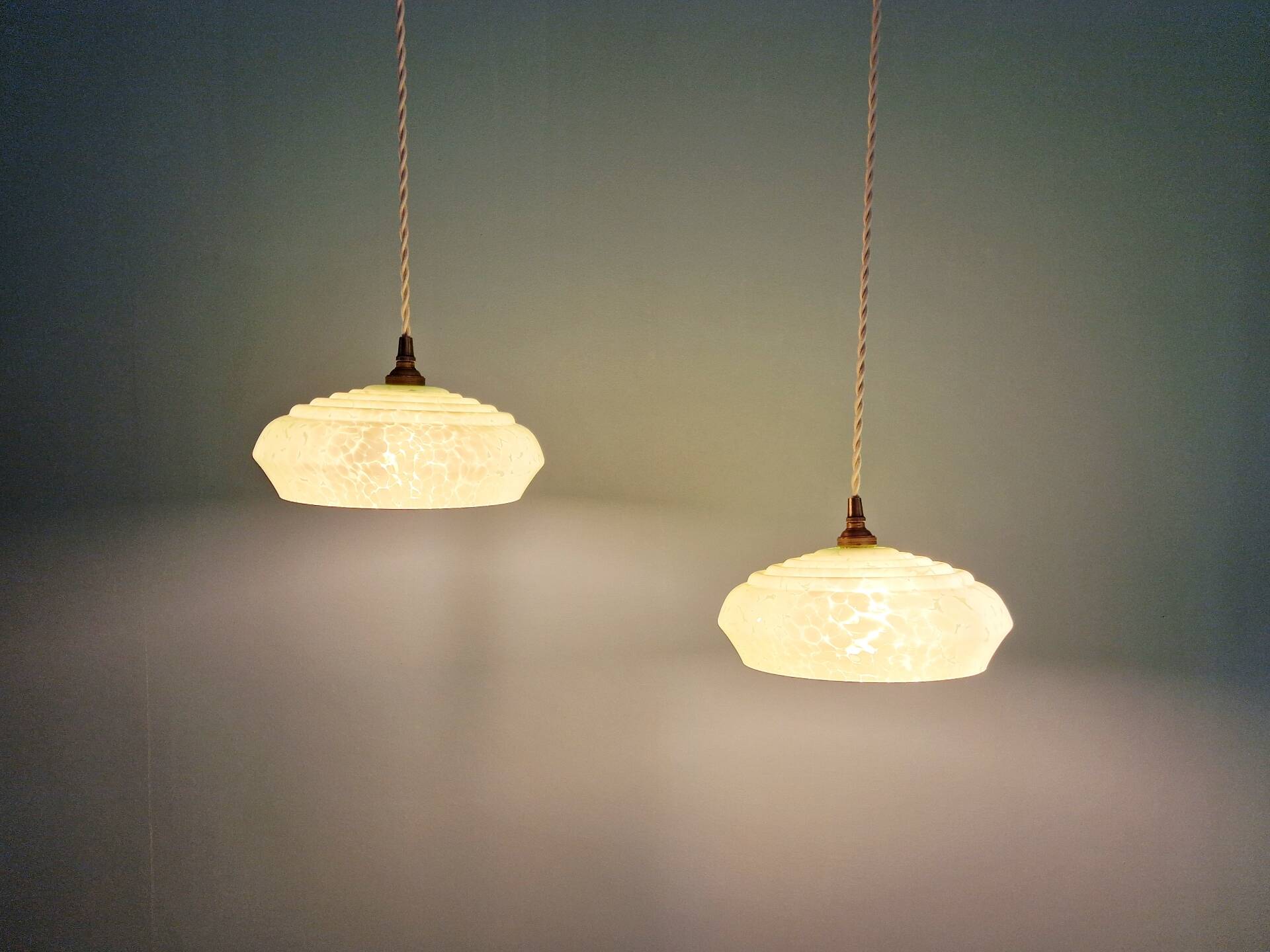 Pair of Art Deco light fixtures in light green speckled glass, 1930s.