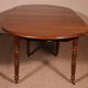 Extensible dining table from the early 19th century in walnut.