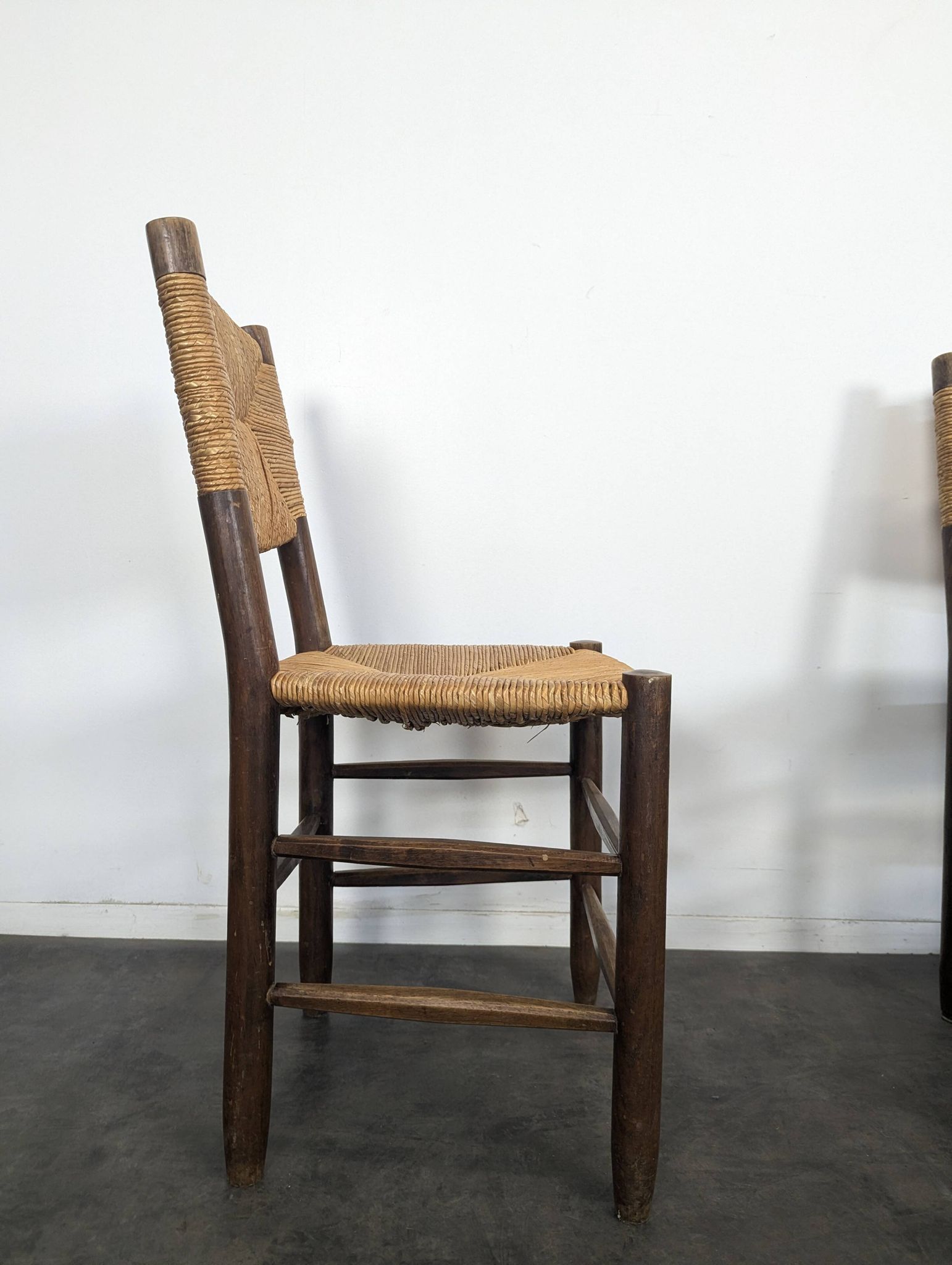 Set of 10 Bauche model chairs by Charlotte Perriand, circa 1960.