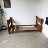 Brutalist style bed with chain and straw