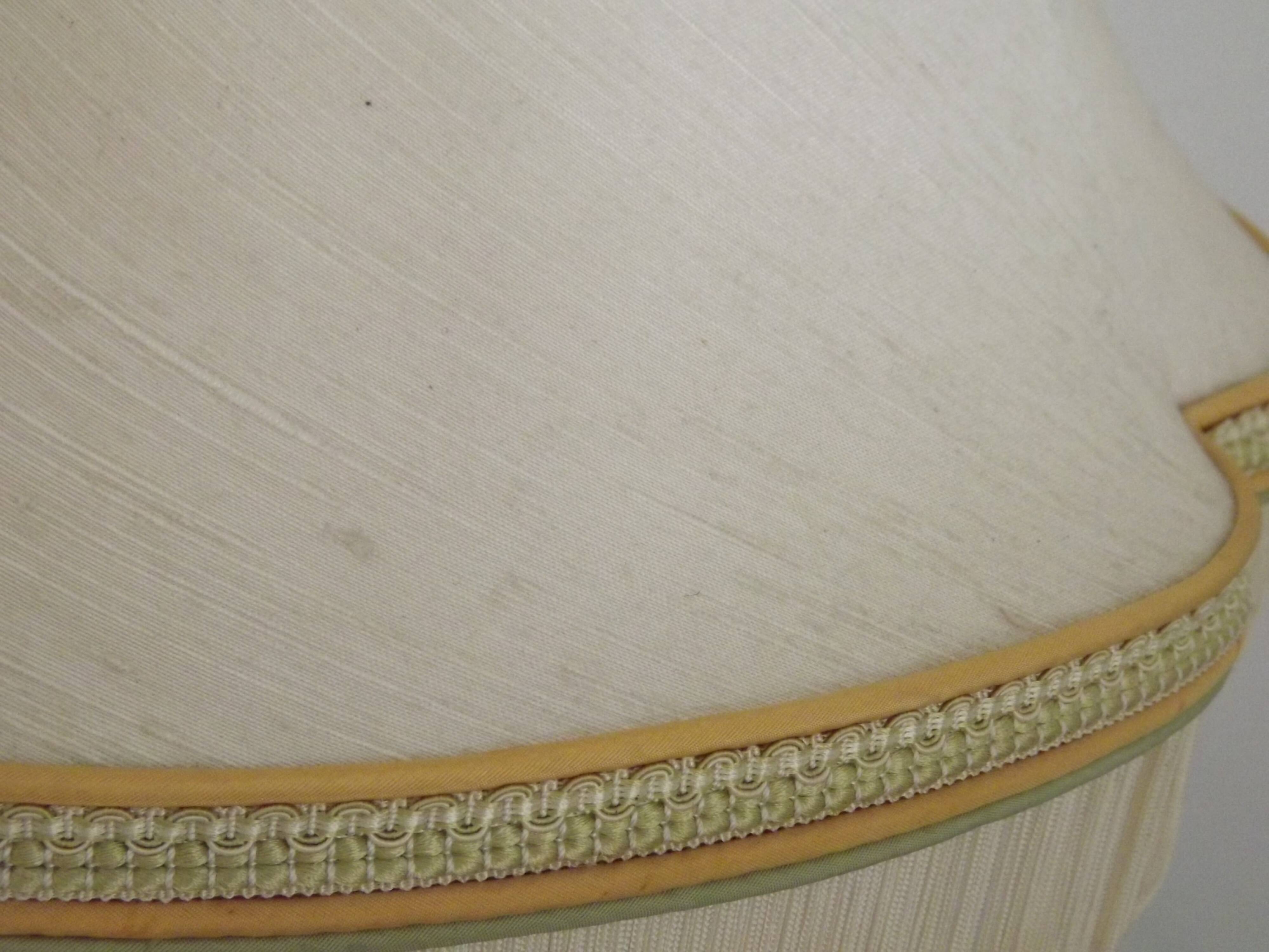 Table lamp with wooden base and fringed shade