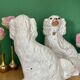 Pair of Staffordshire-type dogs in white and gold ceramic