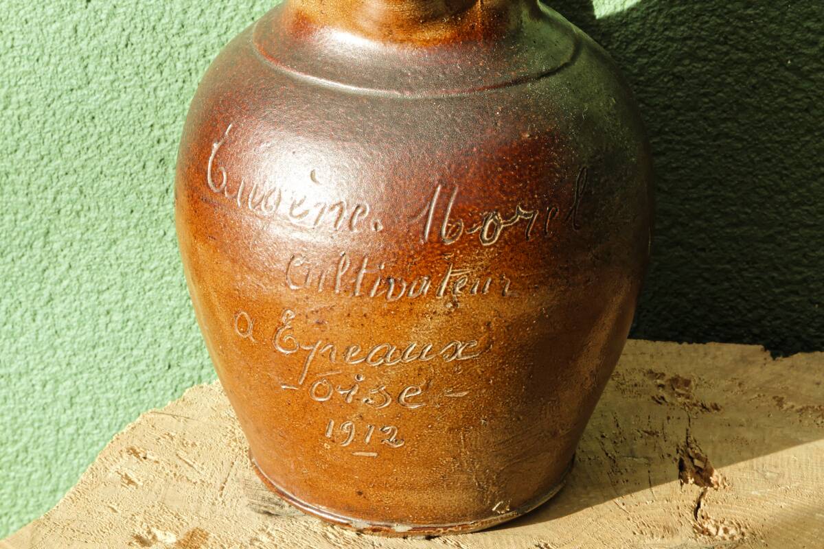 Large stoneware jug with a family name pattern, 1912