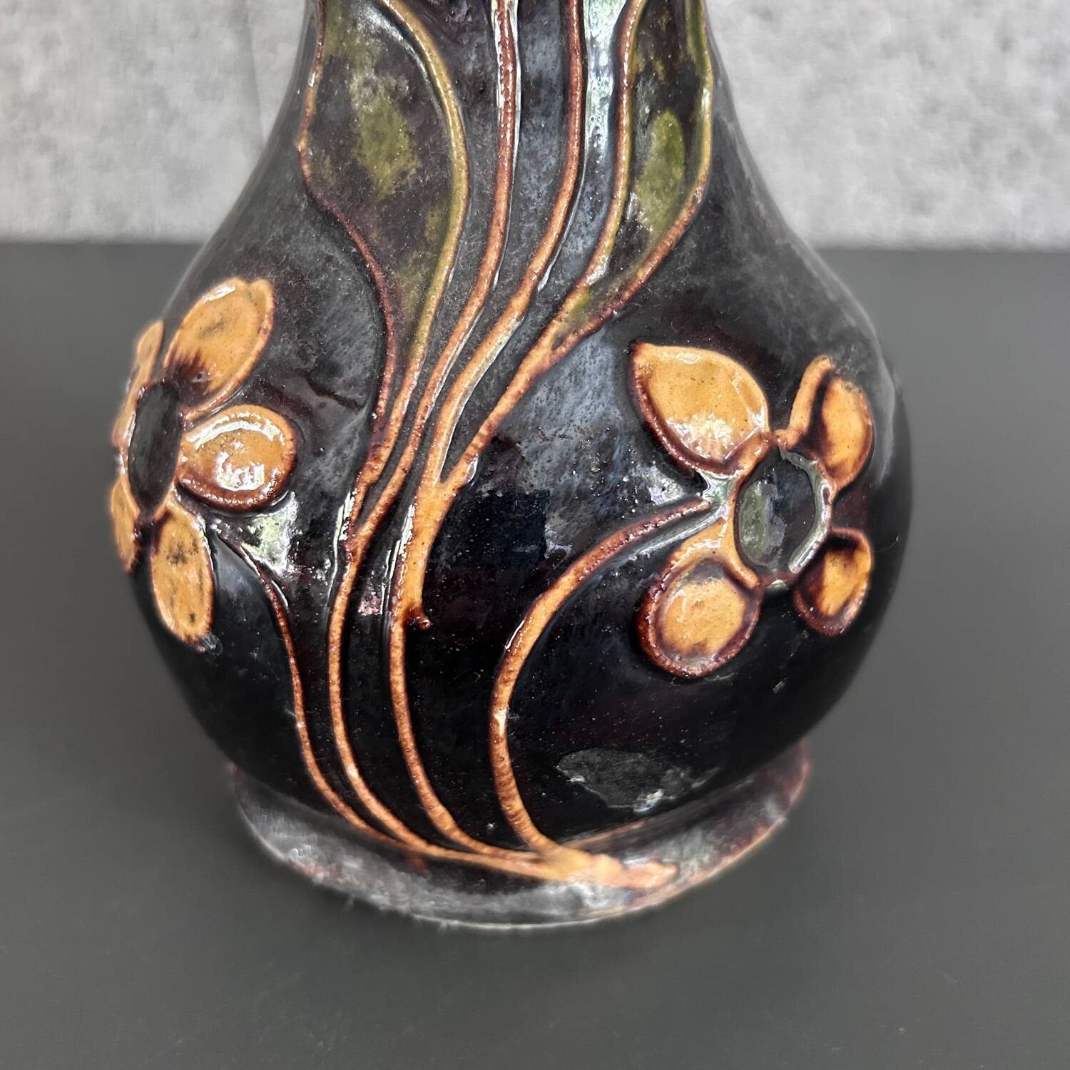 Black vase with yellow flowers
