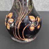 Black vase with yellow flowers