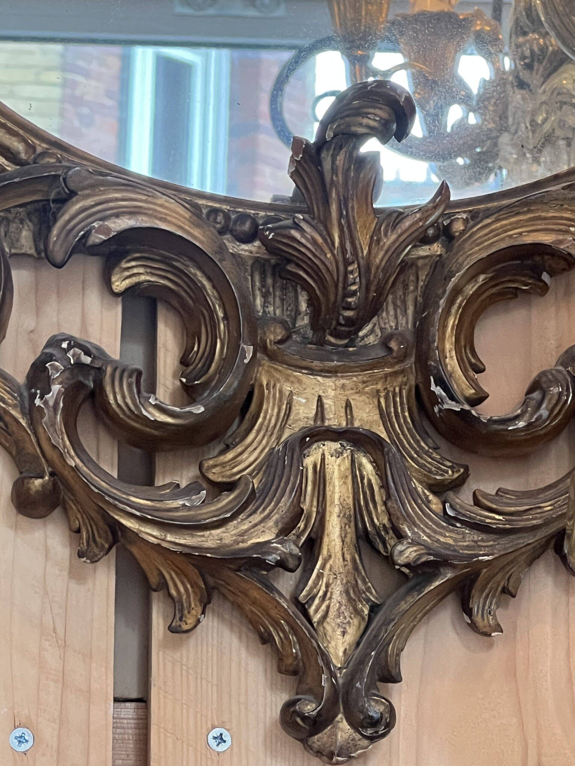 Large gilded wooden mirror, richly carved with winged dragons, 19th century