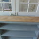 Vintage shallow bookcase, re-enchanted in gray green, wooden tray.