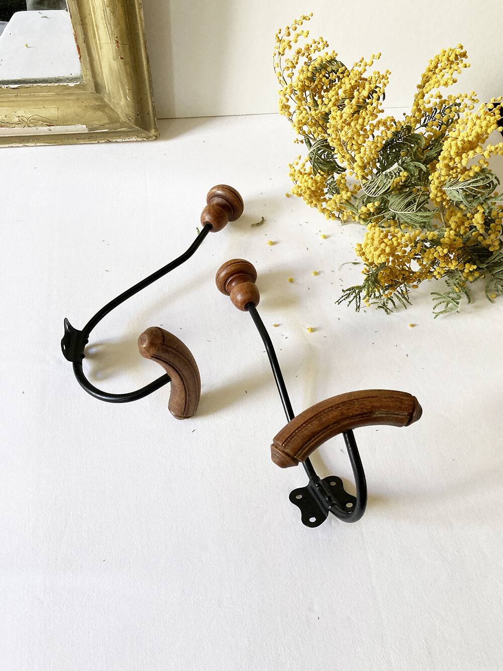 Pair of antique wooden and metal coat hooks