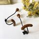 Pair of antique wooden and metal coat hooks