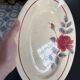 Oval plate Moulin des Loups in blue and red ceramic with a floral design.
