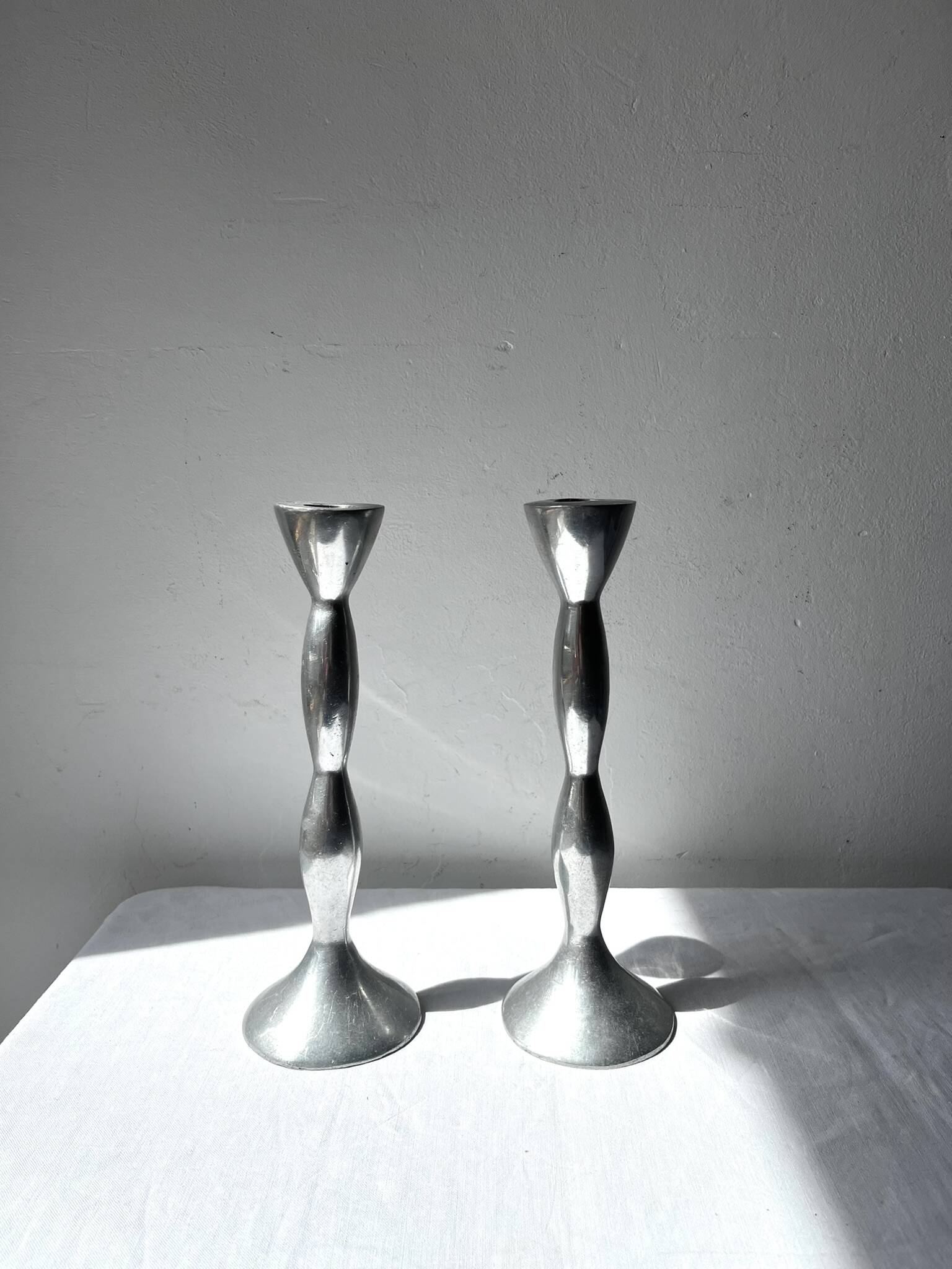 Pair of wavy aluminium candle holders