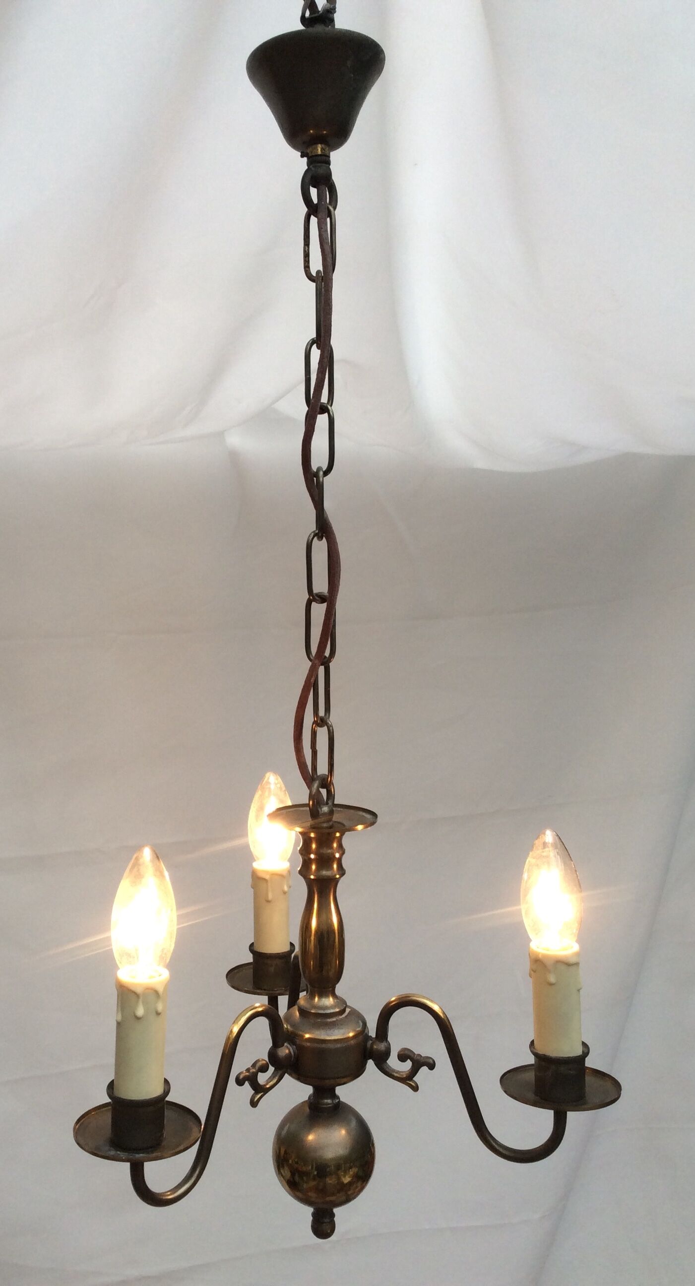 Metal chandelier repainted in copper color with 3 candle-shaped bulbs