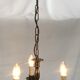 Metal chandelier repainted in copper color with 3 candle-shaped bulbs