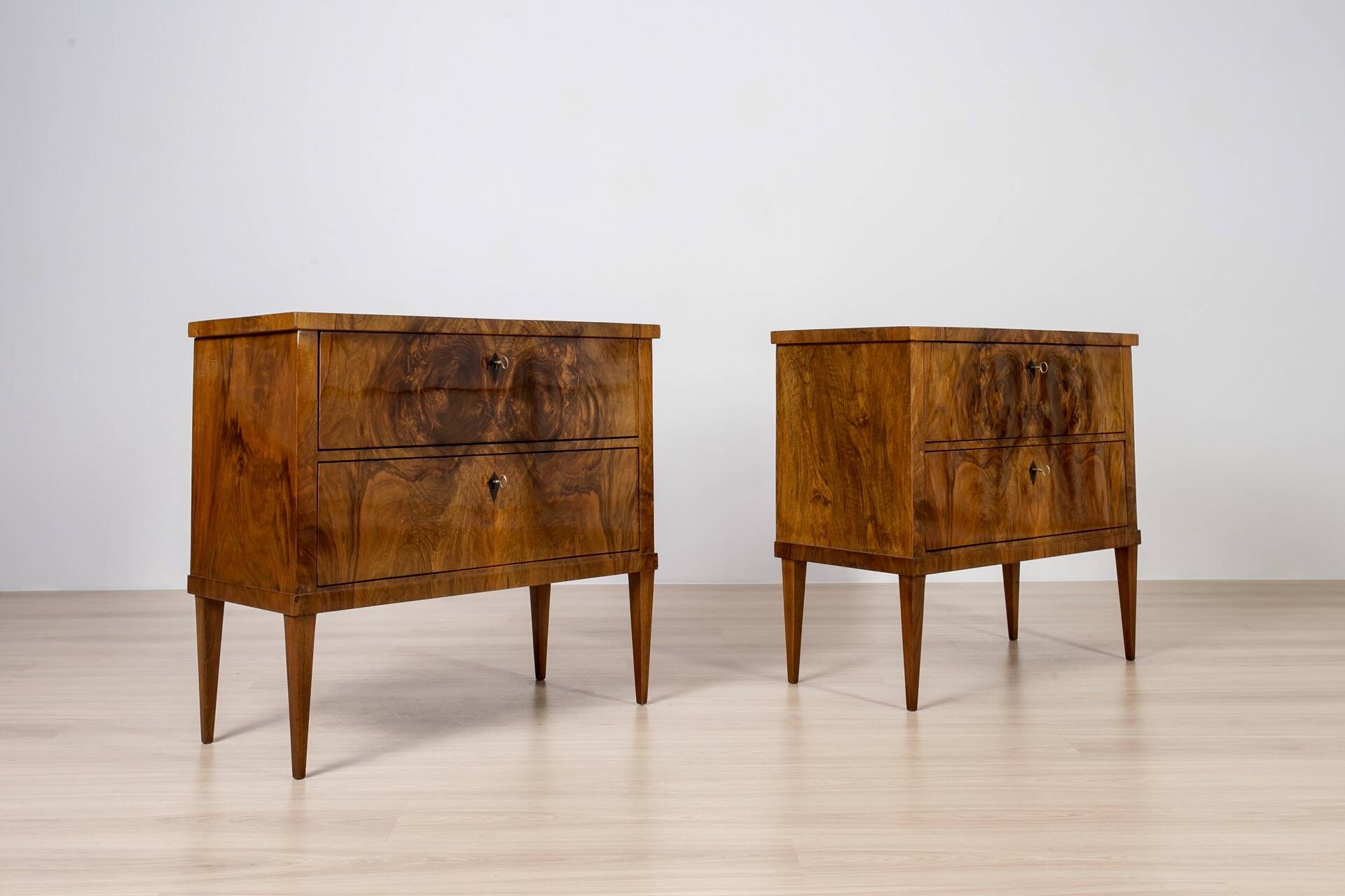 Elegant pair of Biedermeier style walnut commodes, Germany, French polish.