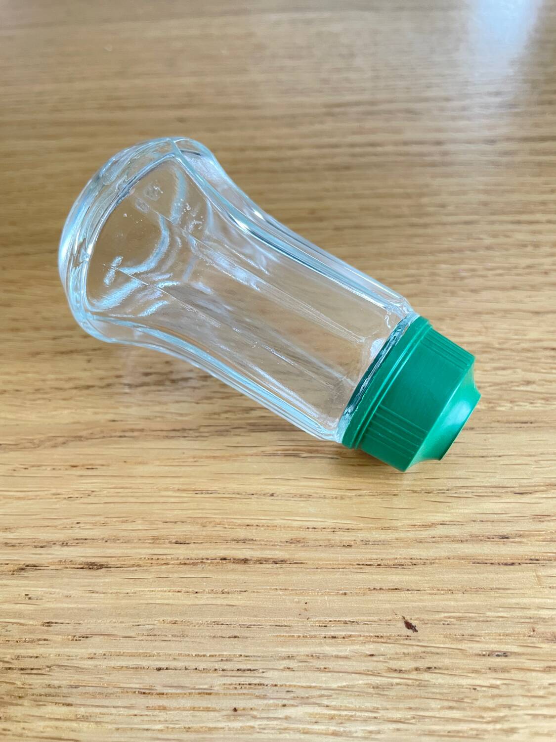 Vintage salt shaker with green Bakelite cap