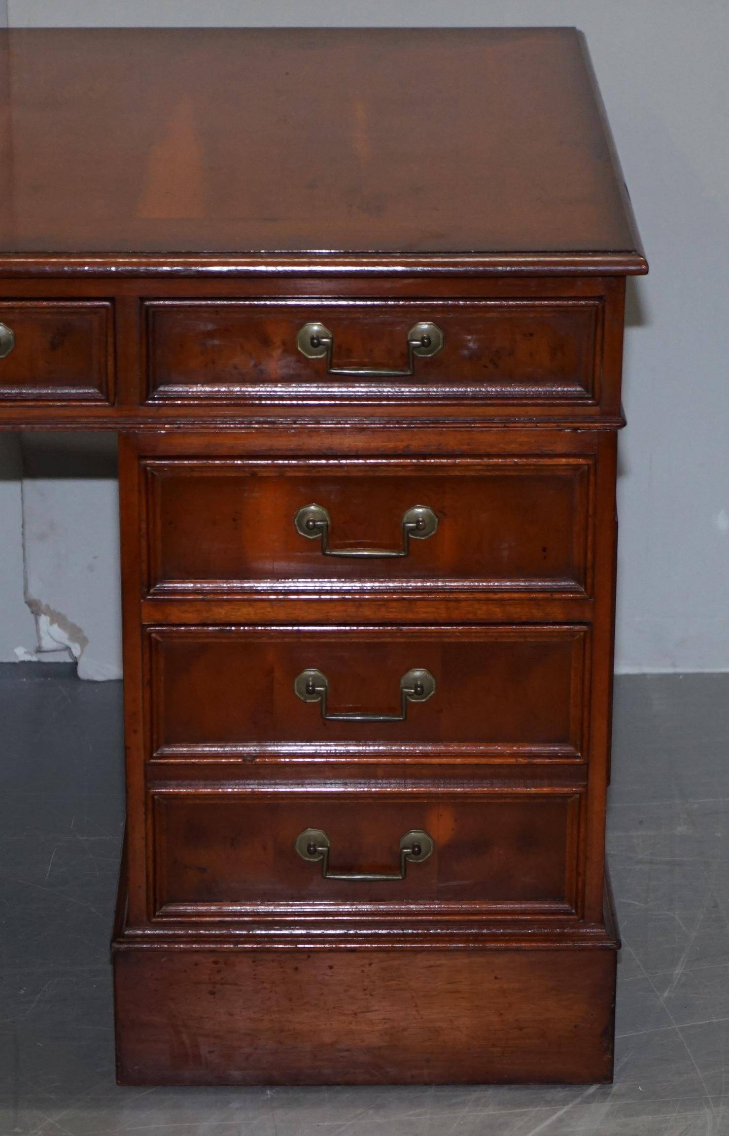 Partner desk with double pedestal in burr yew wood with decorated top.