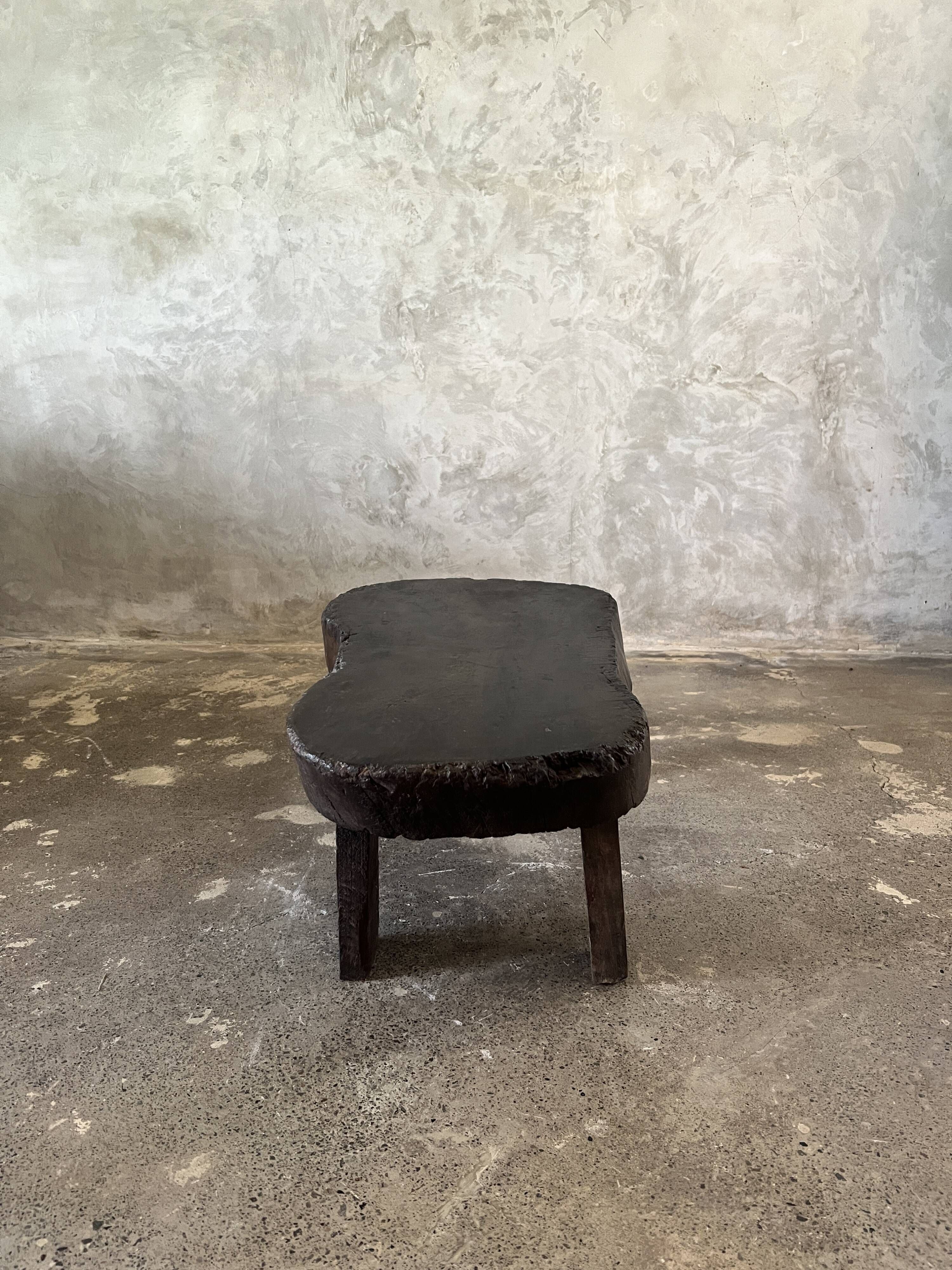 Small old Asian wooden coffee table in Japanese style, kidney-shaped top