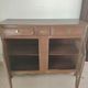 Two low antique buffets in carved solid oak with rosettes.
