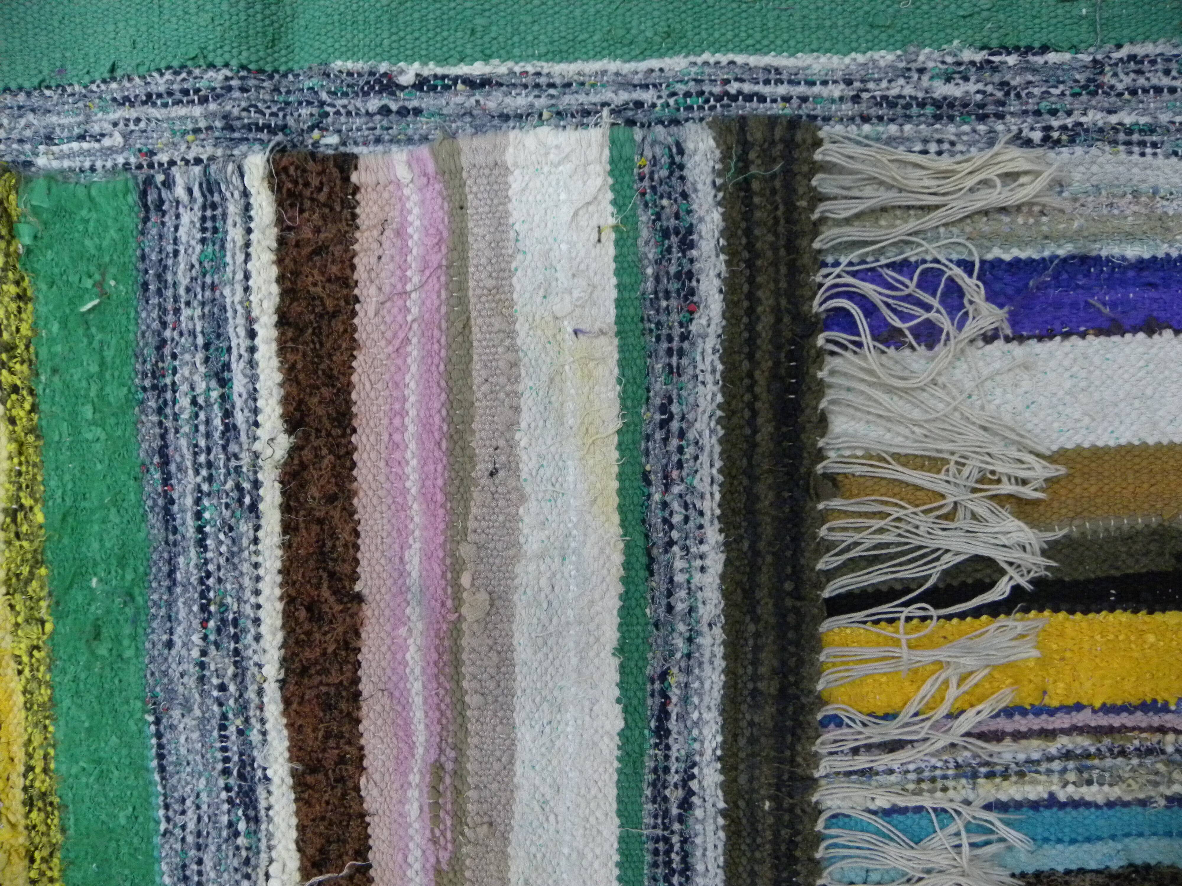 Vintage traditional nomadic kilim ethnic rug with multicoloured stripes.