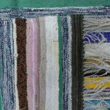 Vintage traditional nomadic kilim ethnic rug with multicoloured stripes.