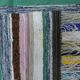 Vintage traditional nomadic kilim ethnic rug with multicoloured stripes.