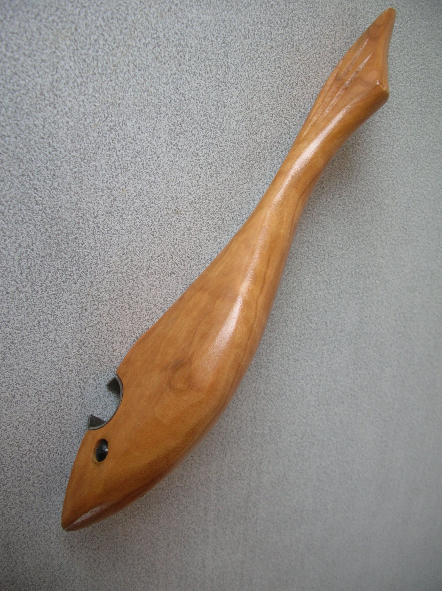 Old bottle opener in the shape of shark wooden fish kitchen utensil