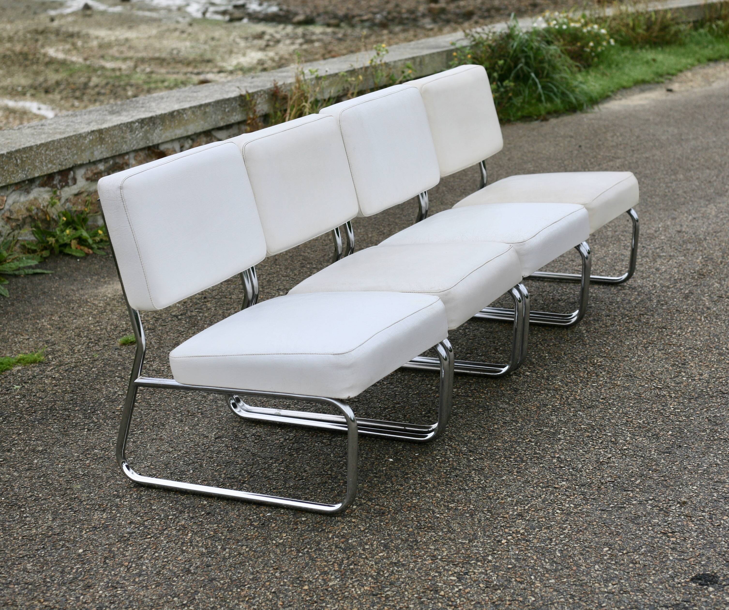 4 armchairs forming a modular sofa. Steel, imitation leather, 70s