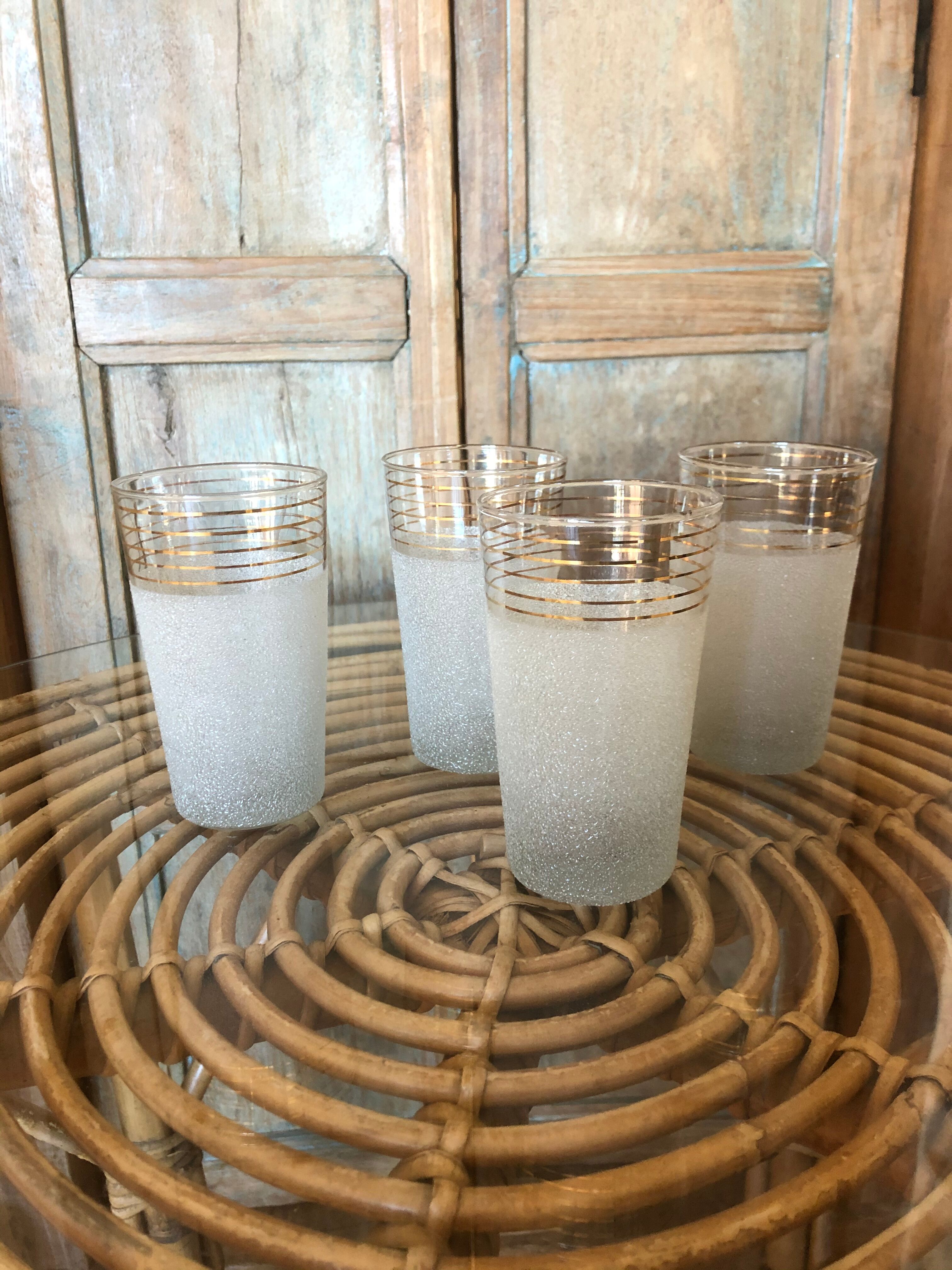 Lot of 4 white granite and gold glasses