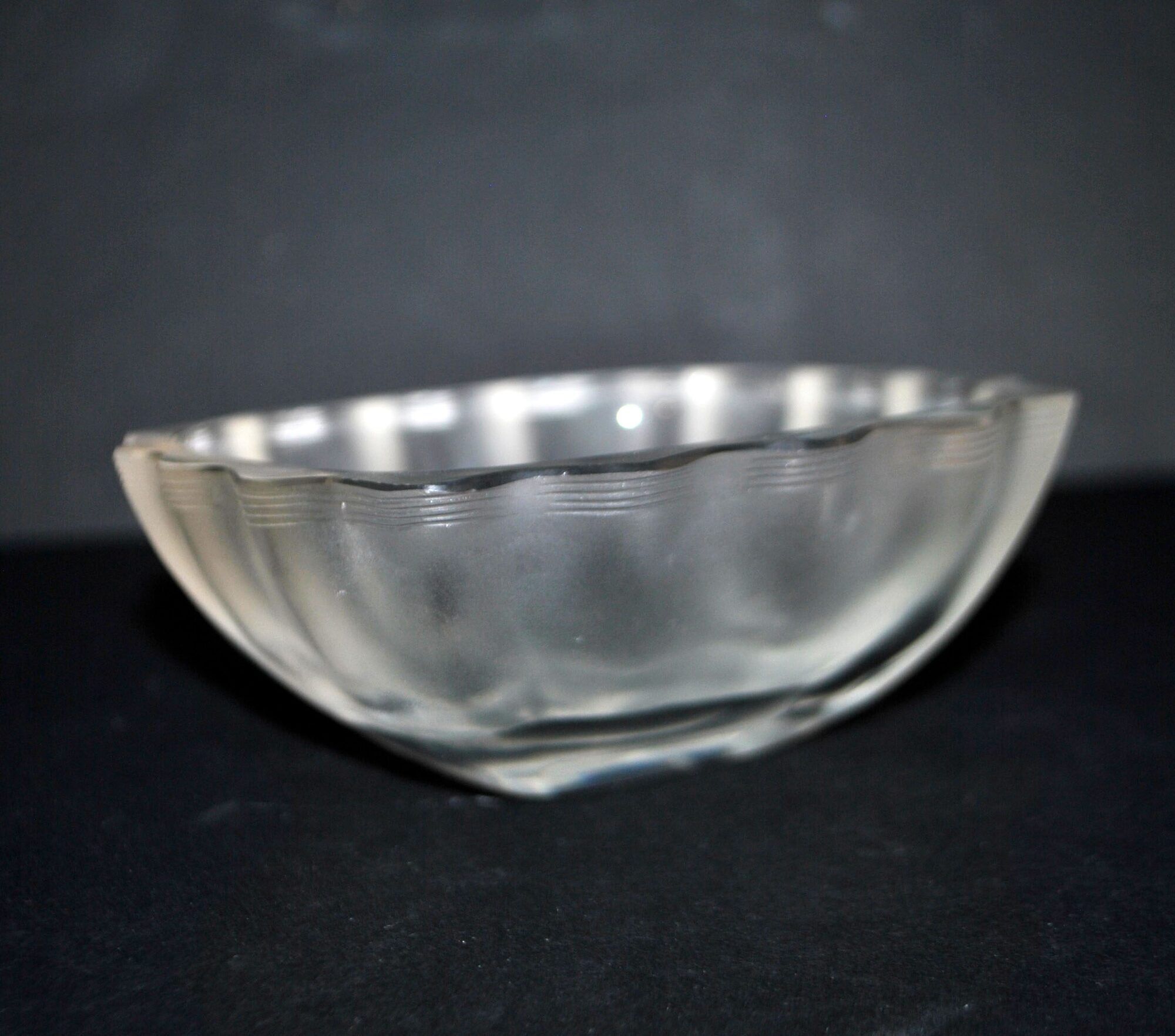 Lalique glass ashtray bowl with frosted finish, engraved with wave design, signed Lalique.