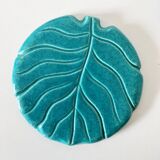 Ceramic trivet and bottle coaster from the 1950s.