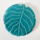 Ceramic trivet and bottle coaster from the 1950s.