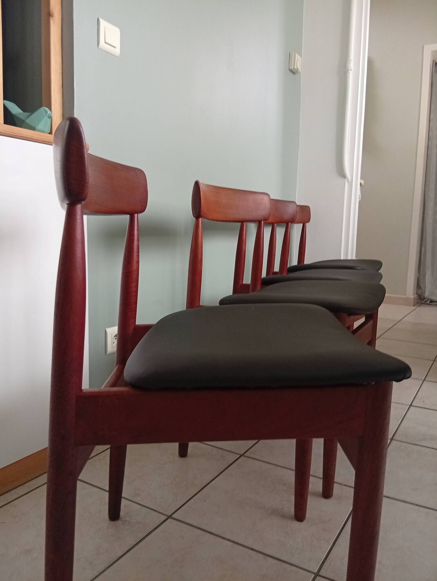 Four Danish mid-century teak armchairs.