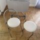 Small stools in metal and faux leather.