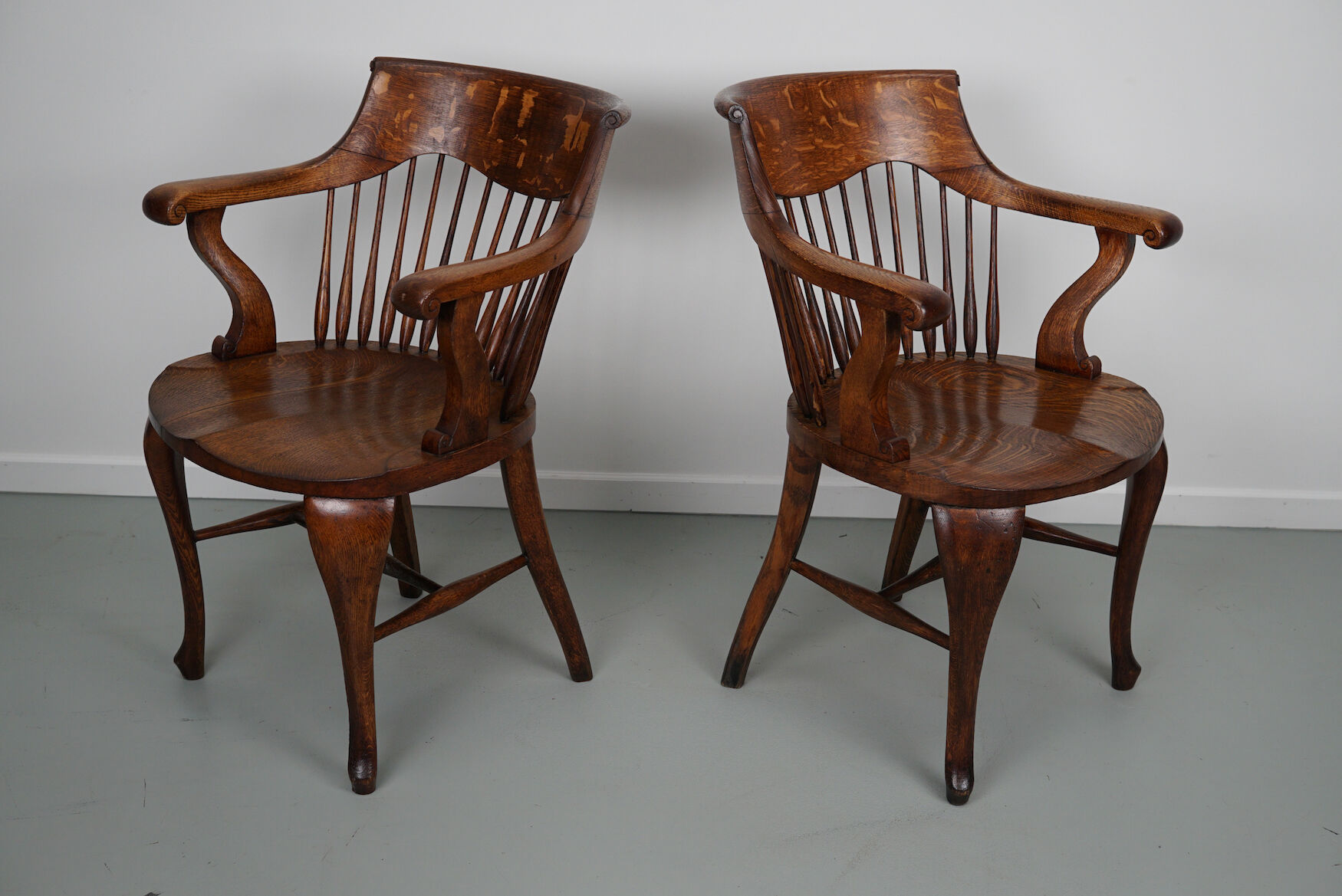 Pair of English Edwardian Oak Spindle Back Captains Office Desk Chairs