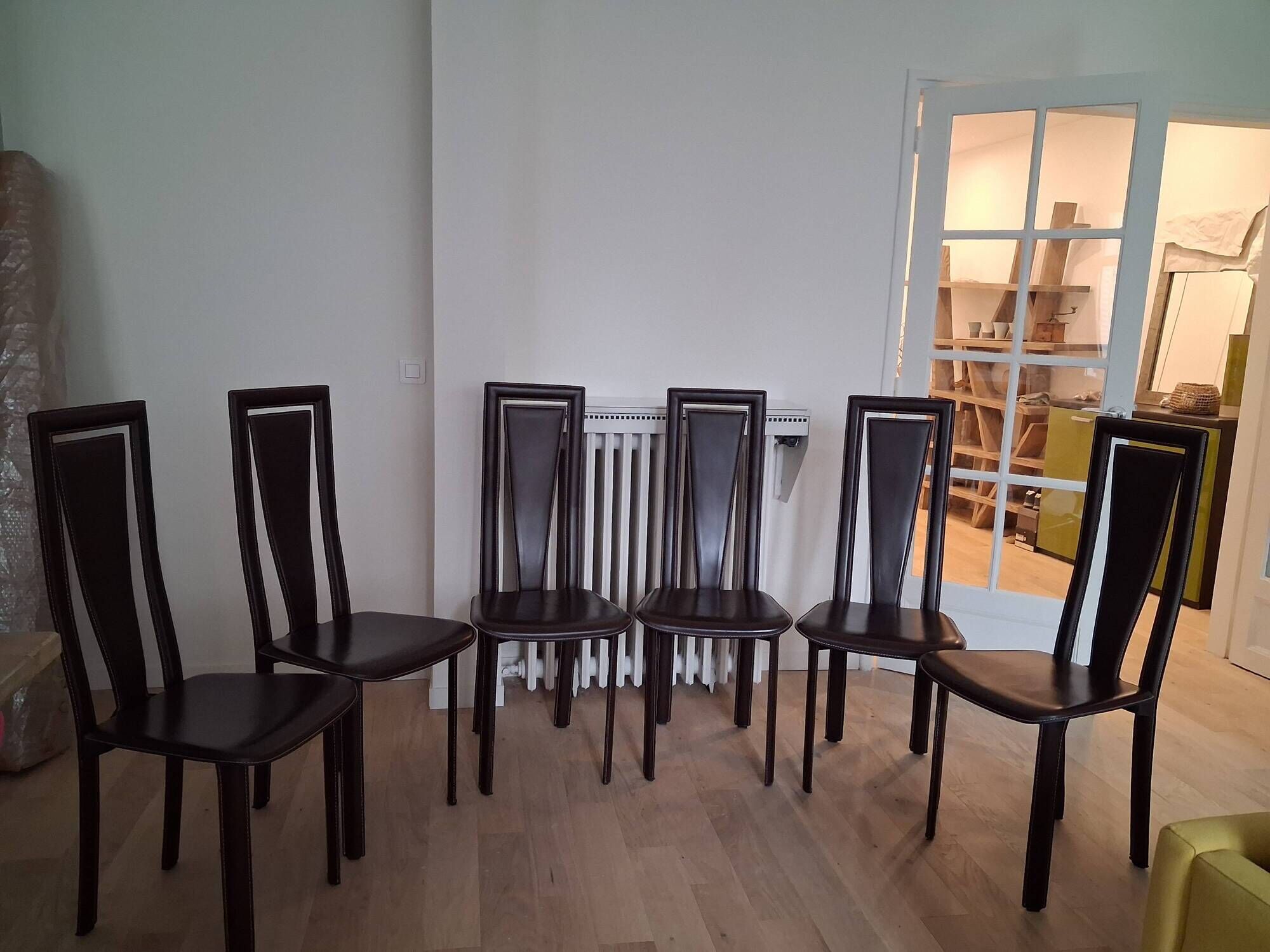 Set of 6 wooden chairs covered in leather.