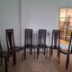 Set of 6 wooden chairs covered in leather.