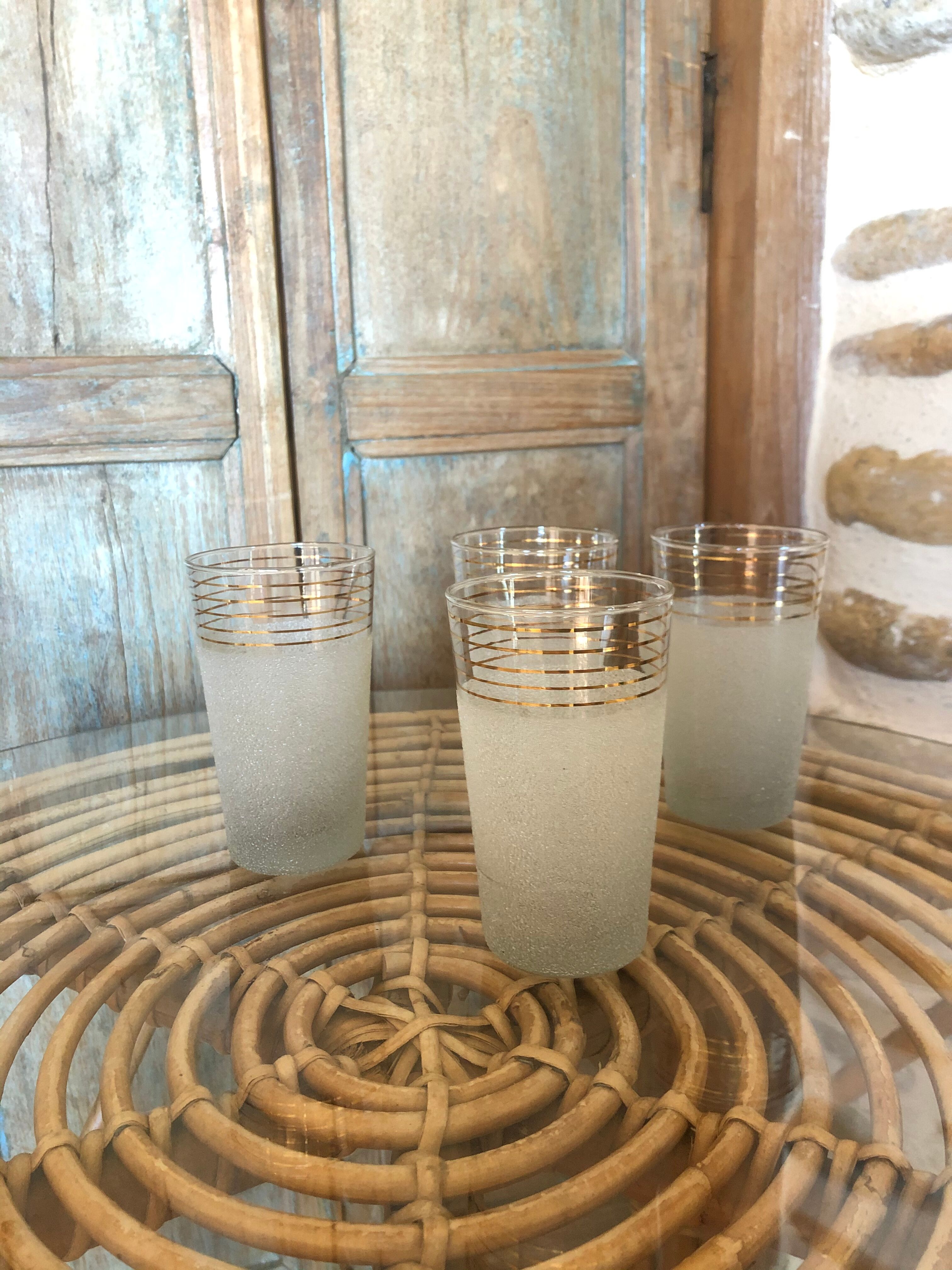 Lot of 4 white granite and gold glasses