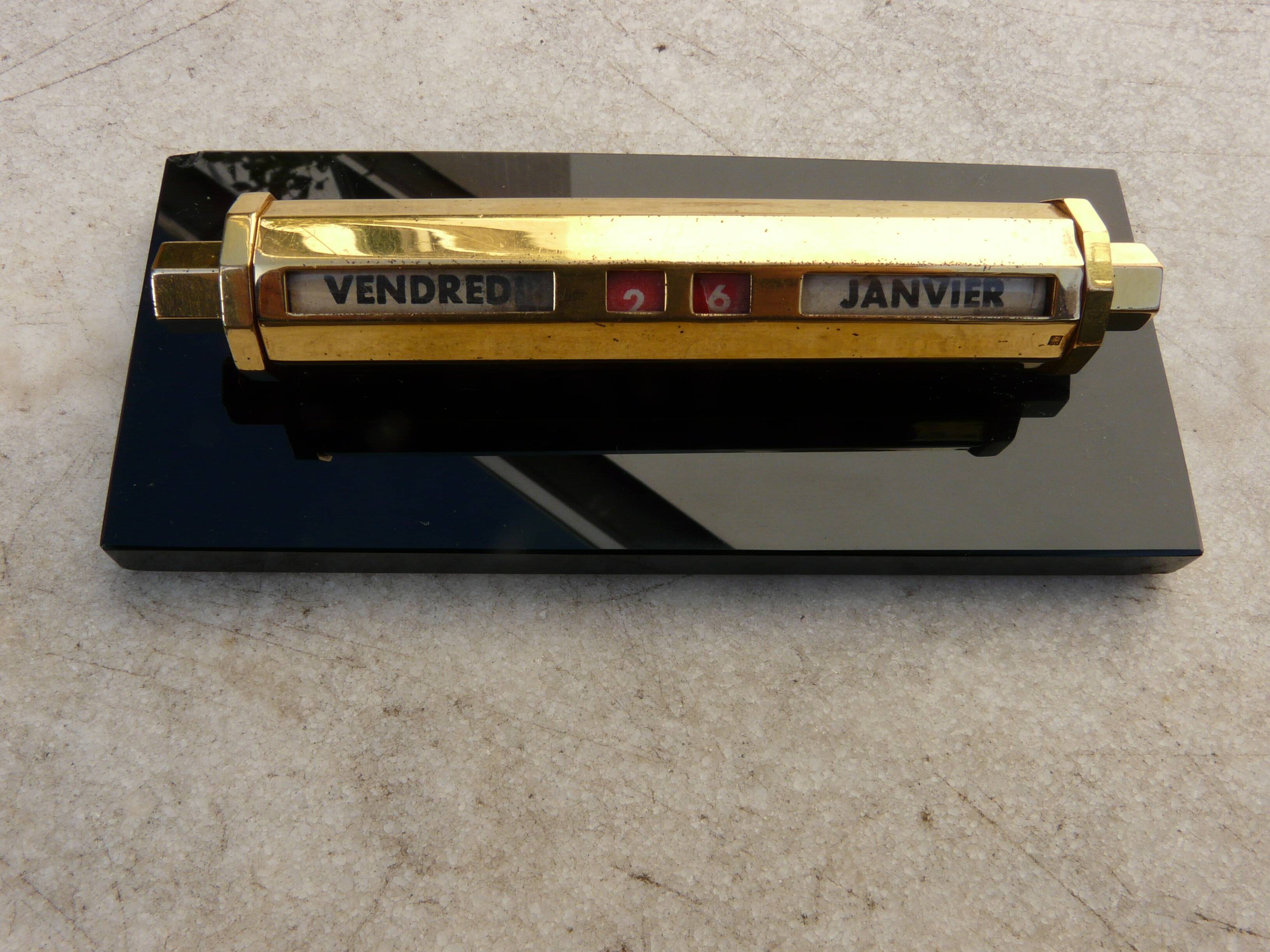 Tubular gold starry perpetual calendar, black base, 1950s