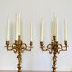 Solid bronze candlesticks decorated with putti, acanthus leaves and lion heads