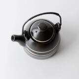 Vintage ceramic teapot from the 1980s, black with white stripes and a metal handle.